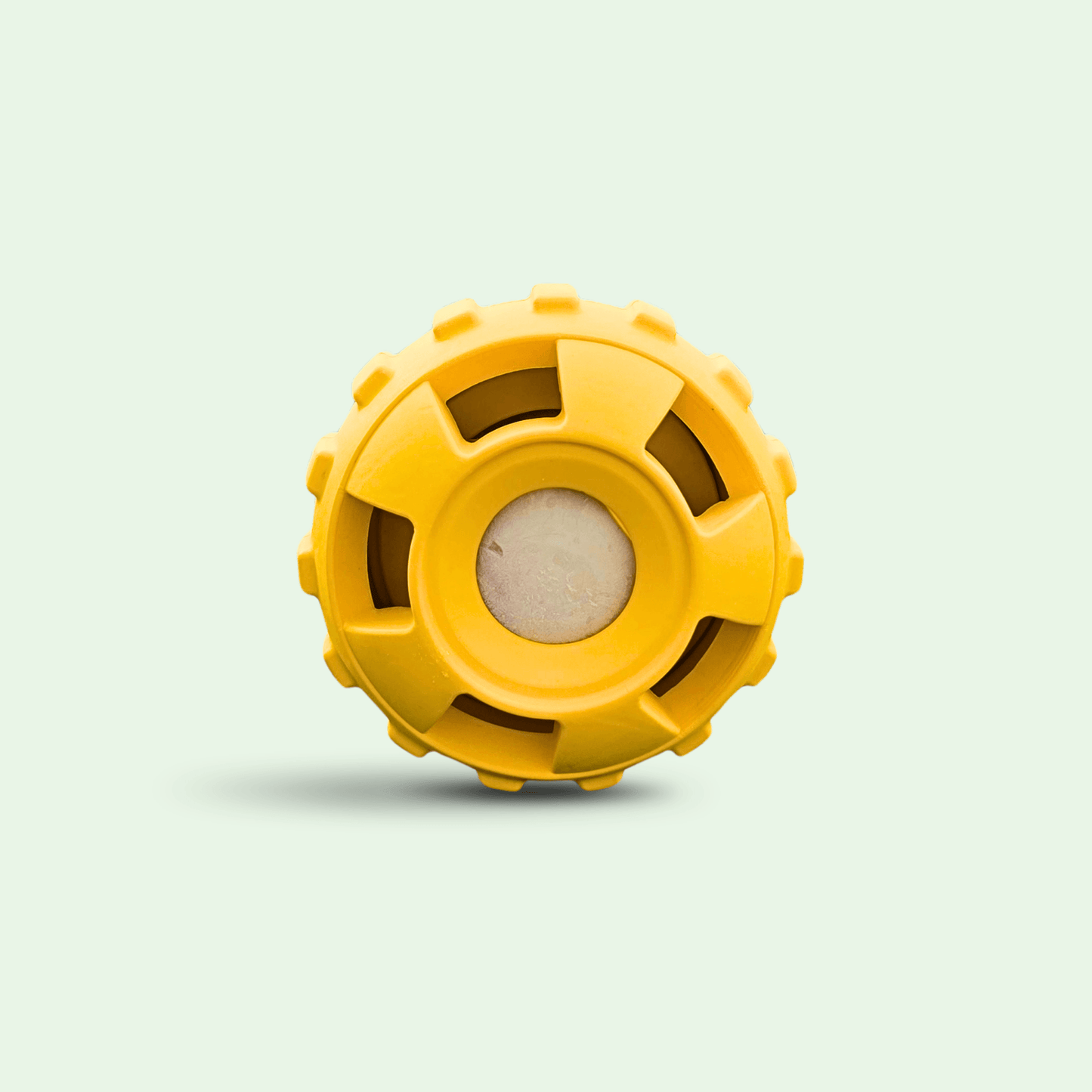 Yellow Woopsi ChillBall interactive dog enrichment toy with a frozen treat inside, isolated on a light background.